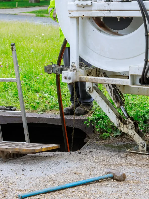 Septic vacuuming out debris from blocked sewer drains